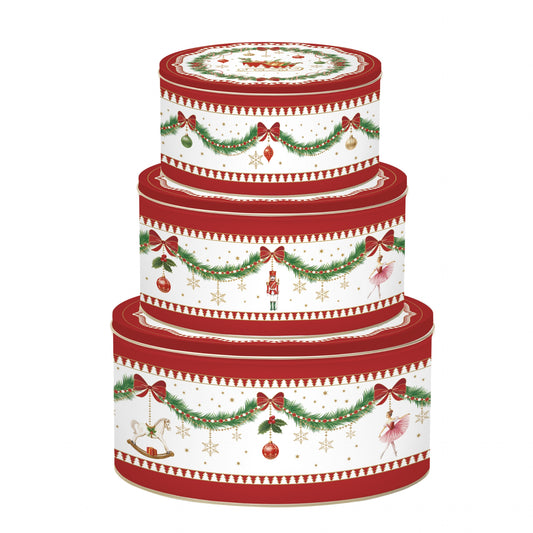 Lot de trois boîtes en métal décorées de motifs de Noël rouges et verts avec guirlandes et houx, empilées par taille.